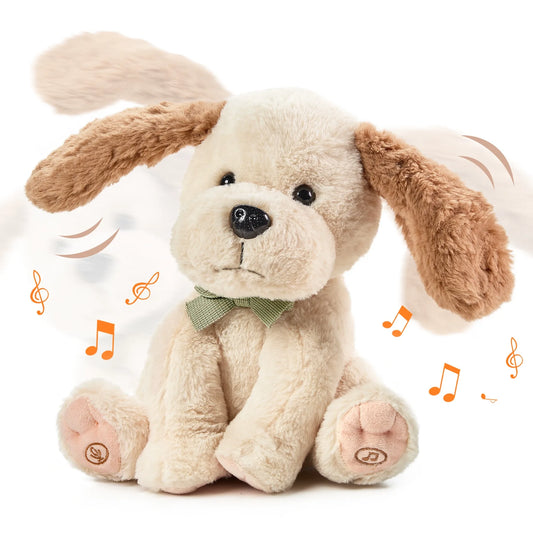 Interactive stuffed animal toy dog featuring soft beige fur, floppy brown ears, and a green bow tie. The dog sits upright, surrounded by music notes and motion lines that highlight its ear-flapping action and sound features.
