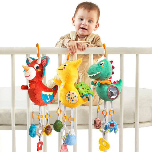 Newborn infant sensory play with baby dinosaur hanging toy