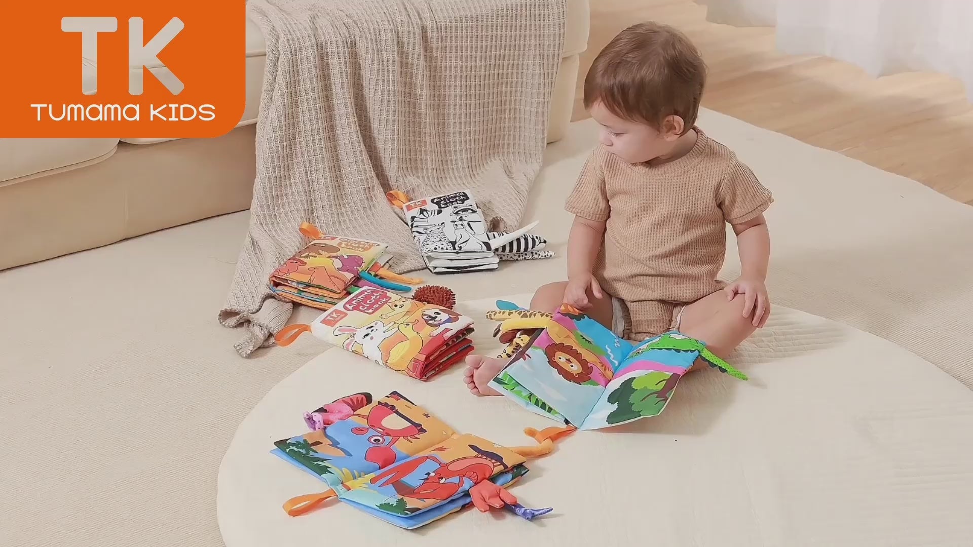 Little-boy-reads-COLORFUL-cloth-books-on-the-ground