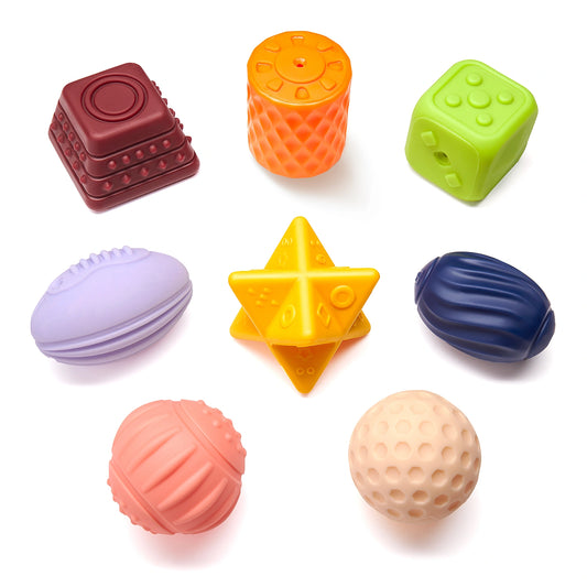 A set of eight colorful textured sensory toys for babies and toddlers displayed on a white background. The toys come in various shapes—cubes, spheres, stars, and ovals—and feature different surface textures such as ridges, bumps, and grooves to stimulate tactile exploration and sensory development.