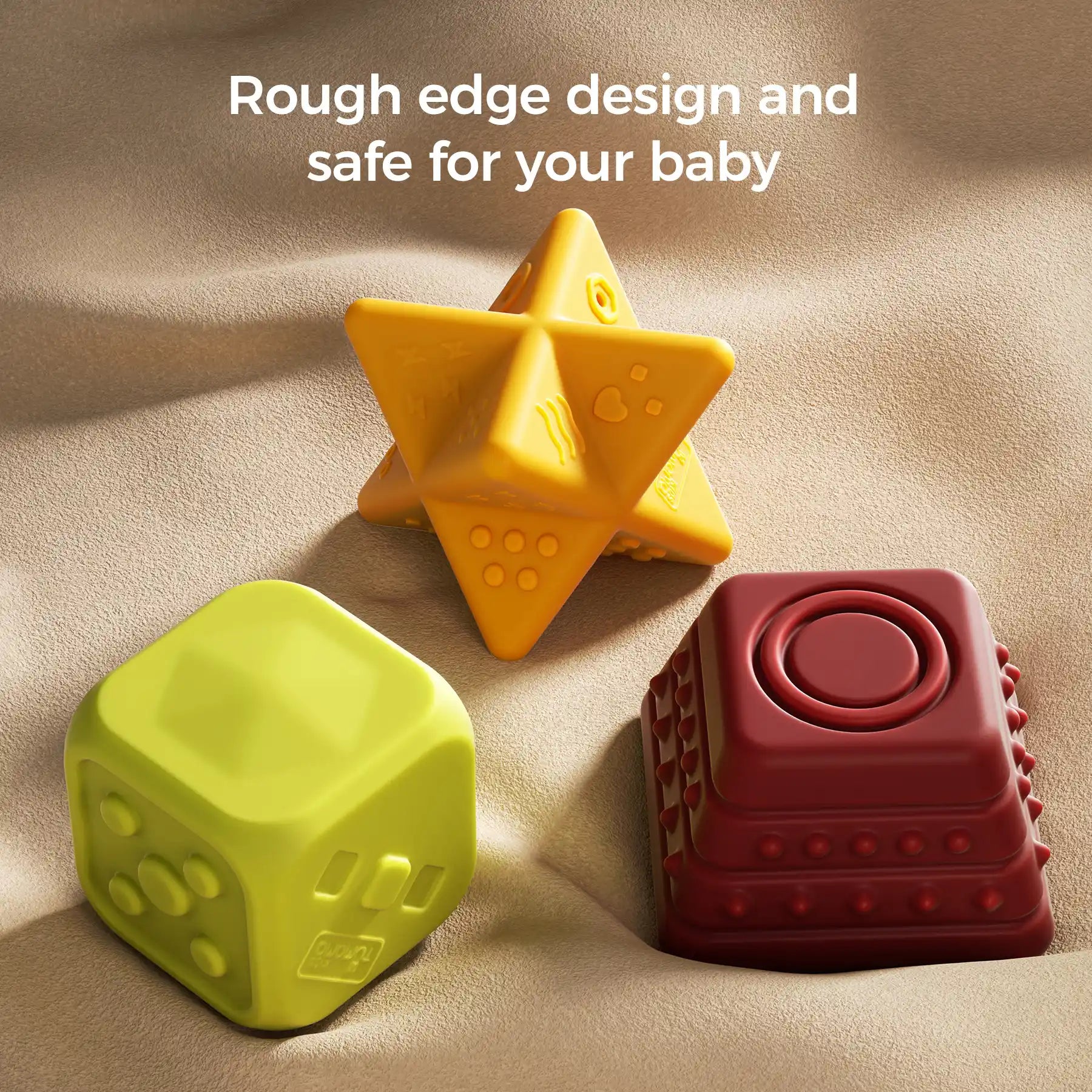 Three colorful textured sensory blocks—a yellow star, a green cube, and a red square pyramid—are displayed on a soft beige fabric surface. Each toy features rounded edges and tactile patterns designed for safe play. The text “Rough edge design and safe for your baby” appears at the top, highlighting their baby-safe construction.