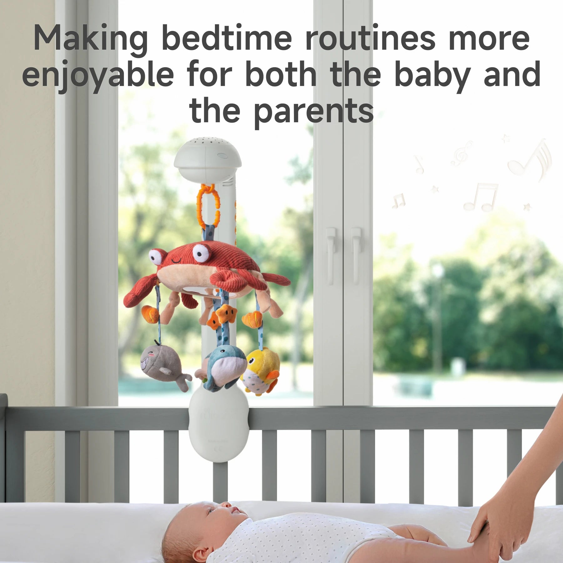 A baby lying in a crib looking up at a plush sea animal mobile with a red crab and ocean-themed characters. The mobile is attached to the crib and plays soothing music, creating a calming bedtime environment that helps both baby and parents enjoy the bedtime routine.
