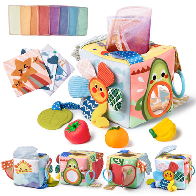 Colorful soft fabric Montessori sensory cube featuring pull-out crinkle rainbow cloth tissues, silicone leaf teether, toy fruits (strawberry, orange, banana), mirror peek‑a‑boo panel, ribbon tags, and animal print panels for tactile exploration.