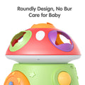 Close-up of the mushroom-shaped baby toy highlighting its smooth, rounded design with colorful shape-sorting holes. The toy features a burr-free surface to ensure it’s safe and gentle for babies to play with.