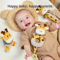 A smiling baby lying on a bed with plush giraffe rattle toys around them, including a ring-shaped giraffe toy resting on the baby’s chest. The baby looks happy and playful. The text “Happy baby, happy parents” is displayed at the top.