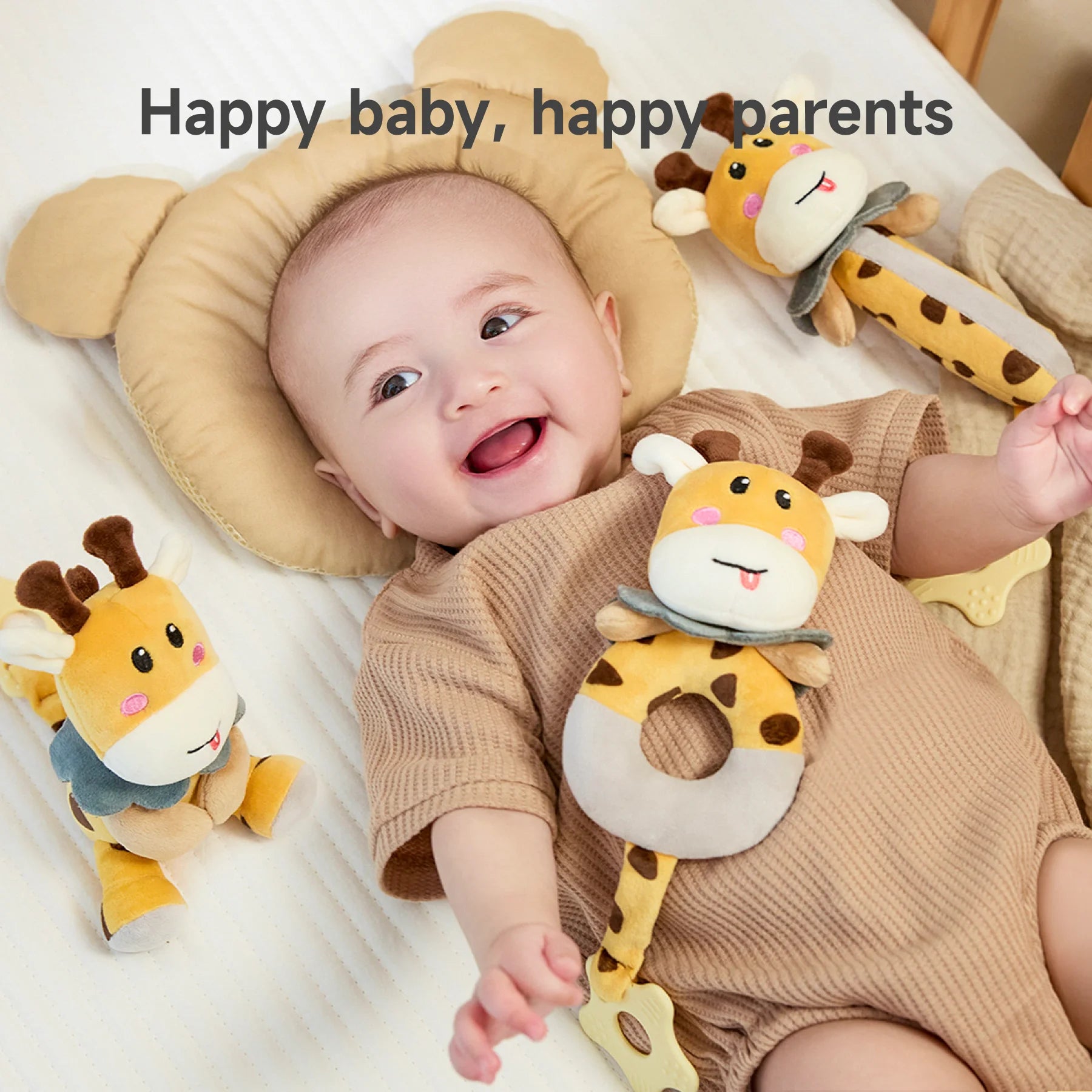 A smiling baby lying on a bed with plush giraffe rattle toys around them, including a ring-shaped giraffe toy resting on the baby’s chest. The baby looks happy and playful. The text “Happy baby, happy parents” is displayed at the top.