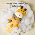 Plush giraffe rattle toy with a star-shaped teether handle, lying on fluffy white cotton filling. The text reads: “Filled with cotton, no deformation.”