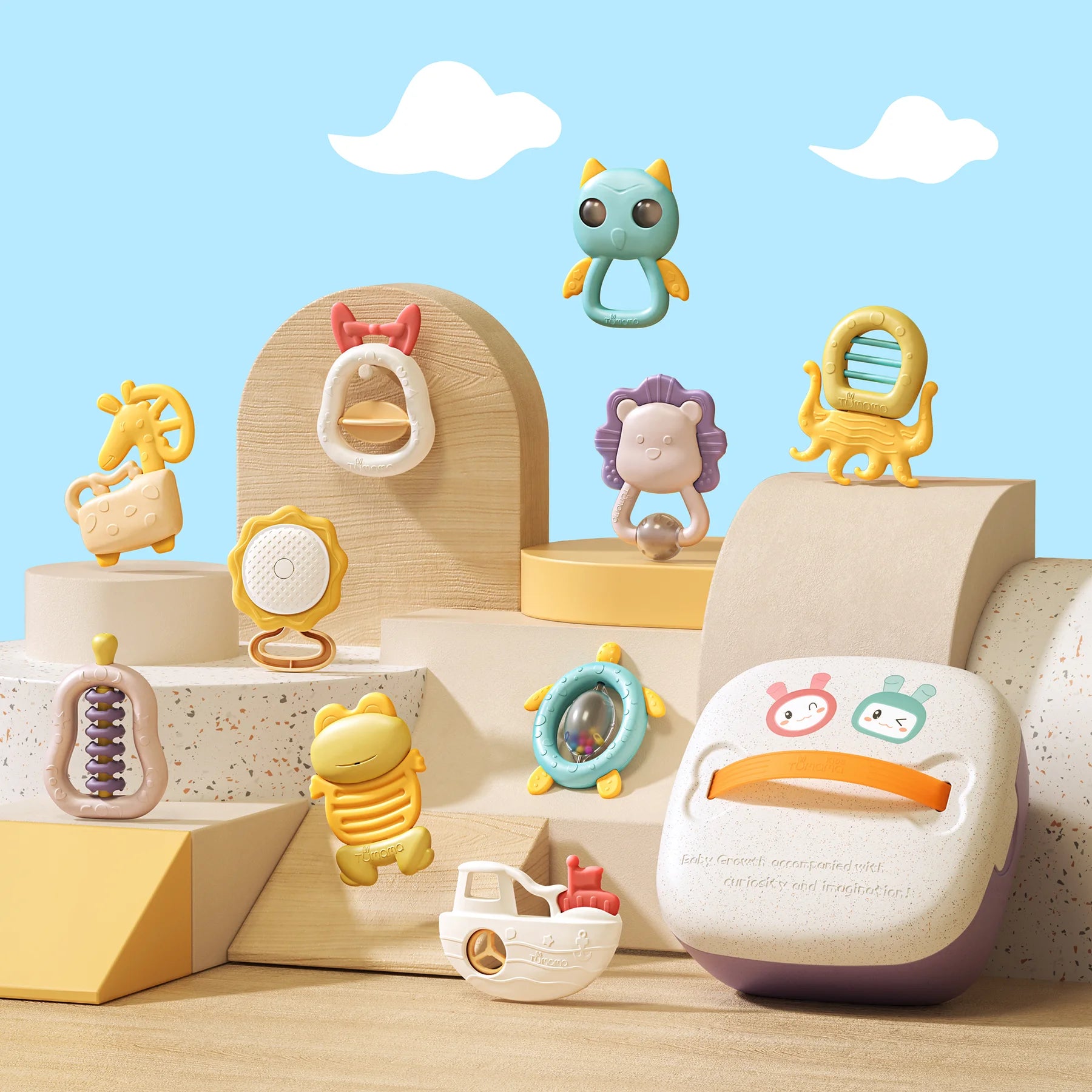 Aesthetic display of a baby rattle and teether toy set arranged on pastel-toned platforms with a blue sky and clouds background. The set includes 12 colorful toys shaped like animals and objects—such as a giraffe, frog, turtle, lion, boat, and more—alongside a storage box with an orange handle. Designed for sensory play, shaking, teething, and grasping.