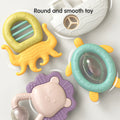 baby rattles and teethers with smooth, rounded edges arranged on a light surface. Designs include a yellow octopus, a white boat, a teal turtle, a purple lion with a clear rattle ball, and a yellow-green circular shape. Text at the top reads “Round and smooth toy,” emphasizing baby-safe construction.