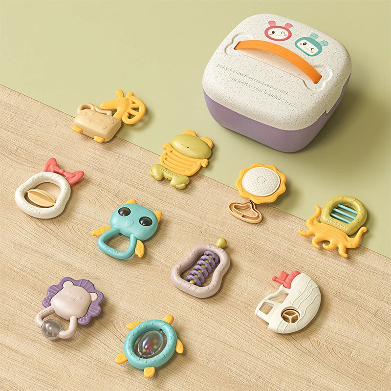 Complete baby rattle and teether toy set arranged around a white and purple storage box with an orange handle. The 10 colorful toys include various animal and object shapes such as a giraffe, frog, turtle, lion, octopus, owl, boat, flower, and abacus, all designed for grasping, shaking, and teething play.