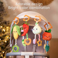 Stroller with four hanging plush baby toys shaped like corn, chili pepper, onion, and pumpkin, featuring bright colors and adorable design for visual stimulation.