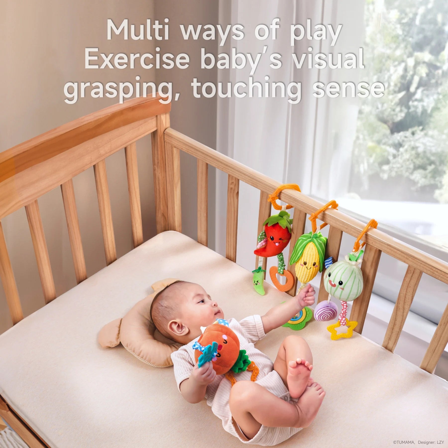 Baby lying in a crib playing with plush vegetable toys, including pumpkin, chili pepper, corn, and onion, which hang on the crib rail to support visual, grasping, and touching development.