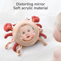 a baby lying on a soft surface while a gently curved, translucent acrylic piece is positioned over part of their face. This reflective element distorts the baby’s features in a playful, whimsical way, creating an amusing visual effect while keeping the infant’s expression calm and unharmed.