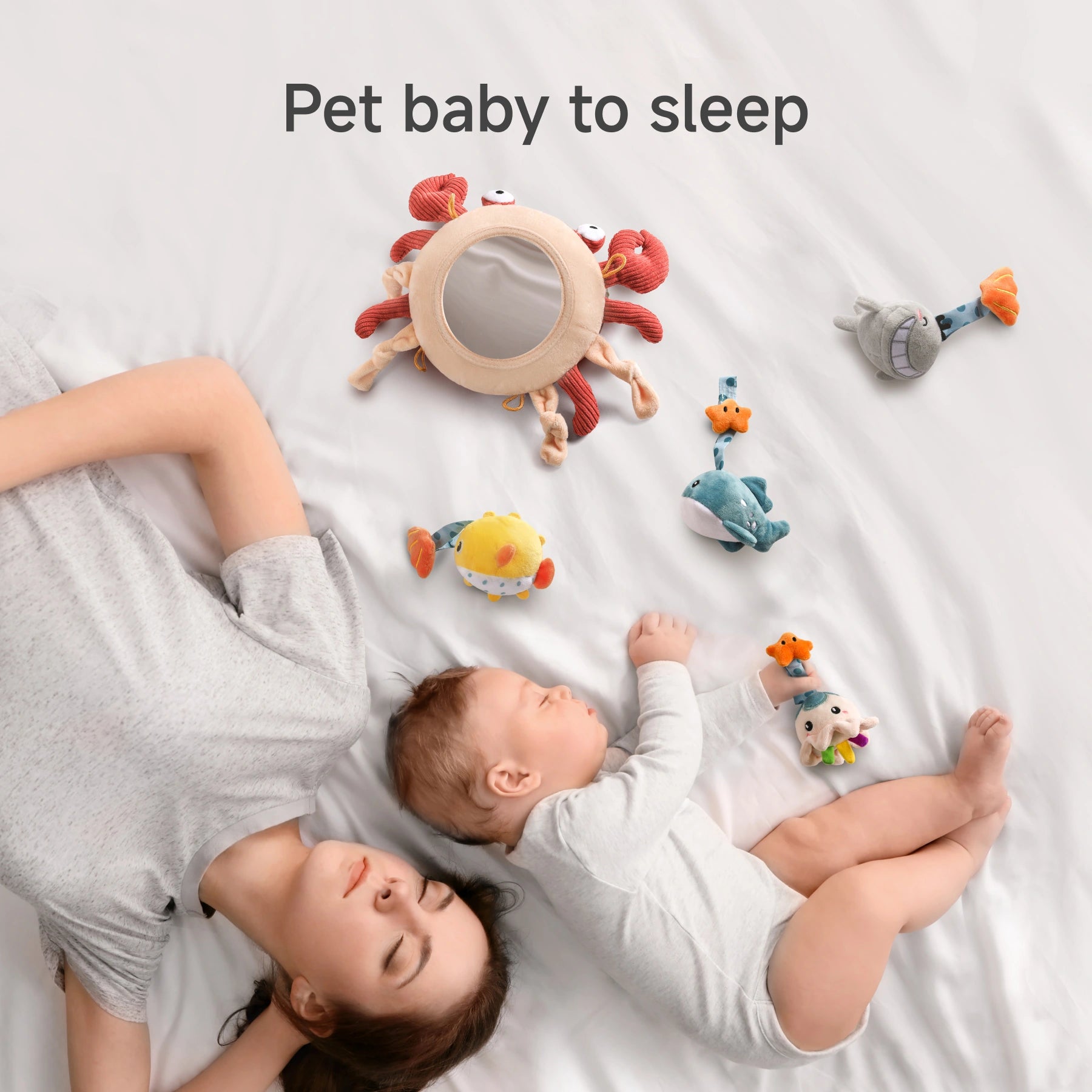 a calm nursery scene where a woman lies on her stomach beside a sleeping baby, both exuding a sense of peaceful rest. Surrounding them are several plush toys arranged with care, including a standout crab with a blue band and a charming fish toy, all contributing to an aquatic theme that enhances the room’s gentle atmosphere.