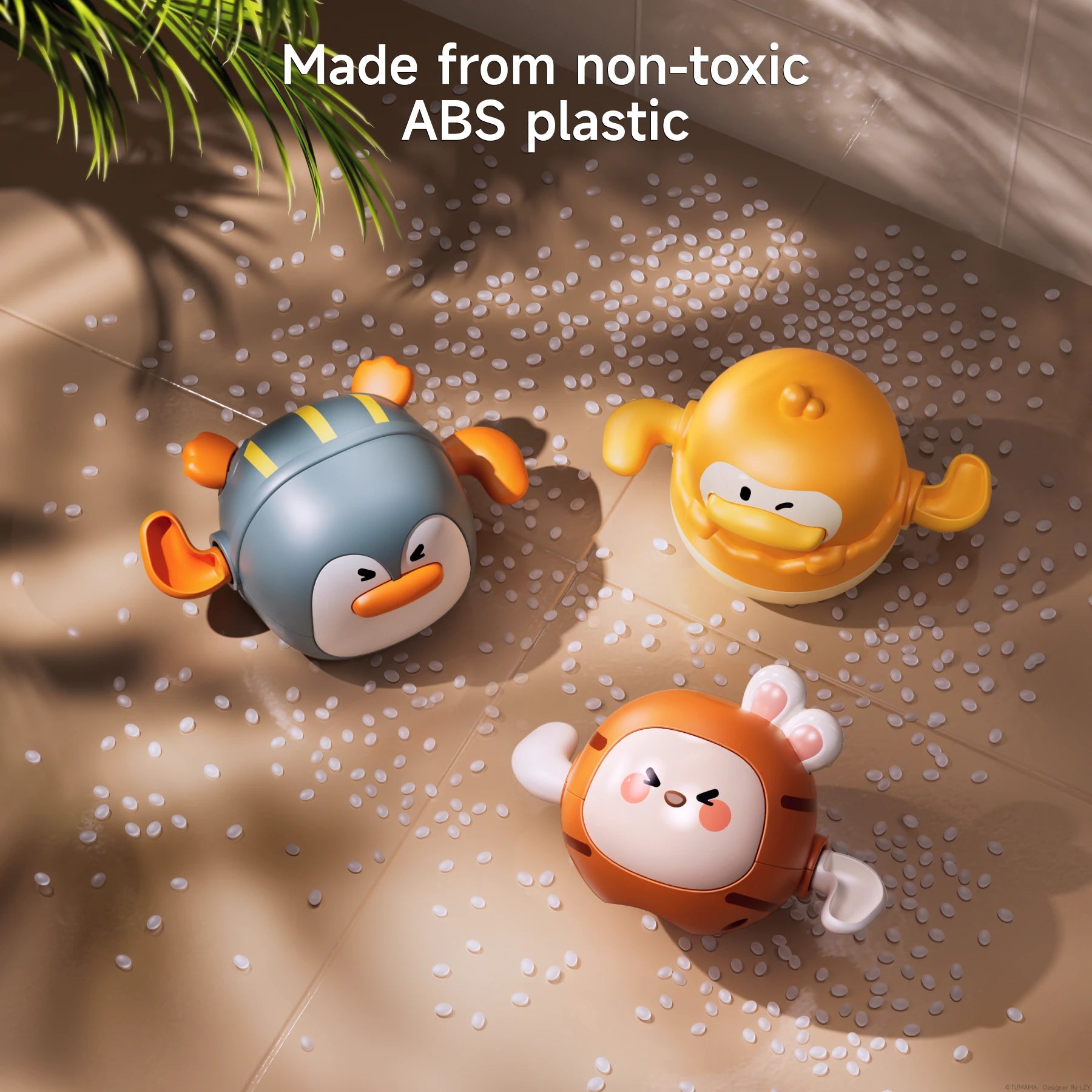 Three colorful wind-up bath toys shaped like a penguin, duck, and bunny are placed on a tiled surface surrounded. Text above reads: “Made from non-toxic ABS plastic.”