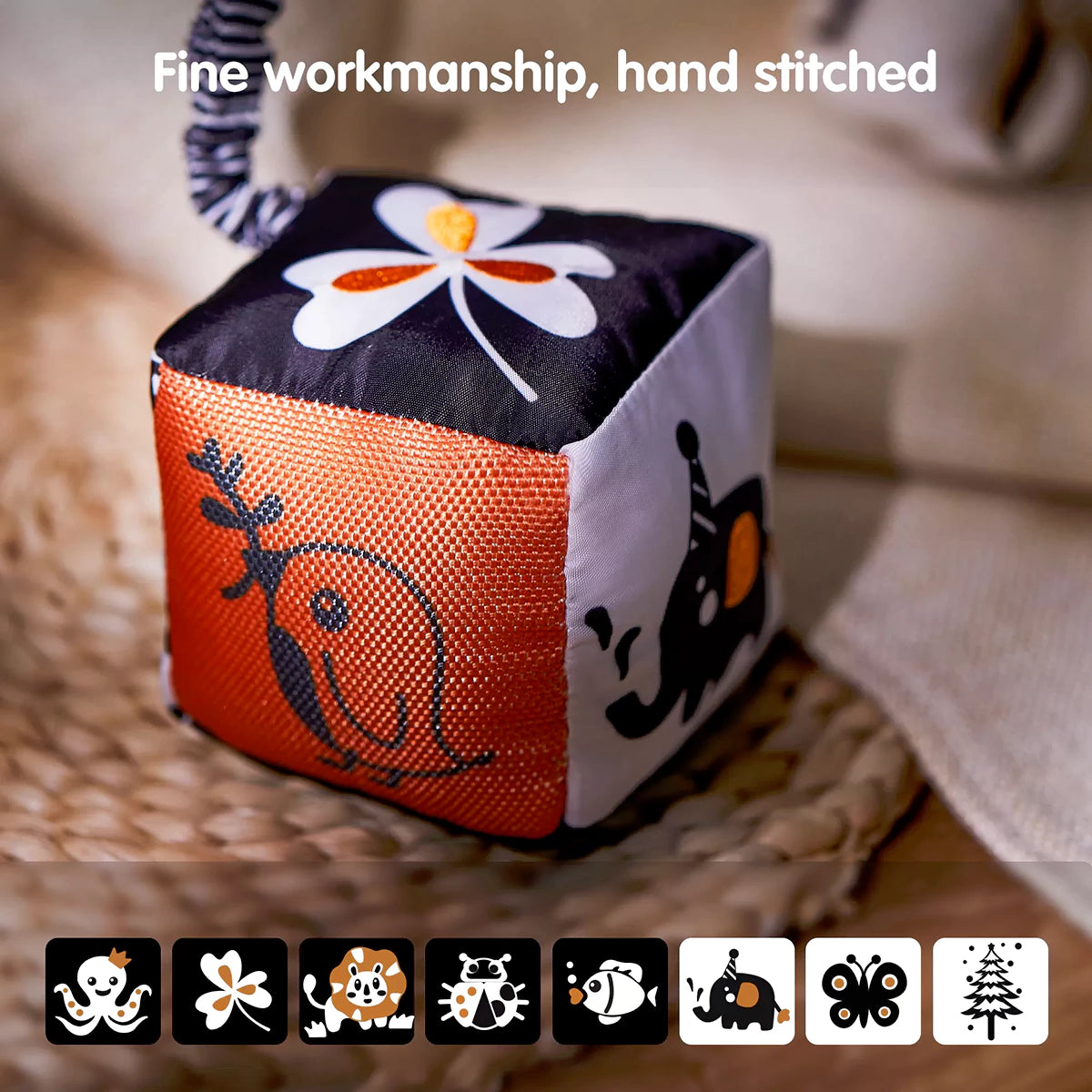 Close-up of a black, white, and orange soft cube baby toy featuring hand-stitched animal and nature-themed designs. The high-contrast visuals aid infant visual development, while the soft texture and durable stitching ensure safe and long-lasting play. Icons below show the various patterns available on the toy’s surfaces.