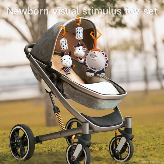 Baby stroller with a hanging newborn visual stimulus toy set attached to the canopy, including two black-and-white cow plush toys, geometric-patterned rattles, and a round baby-safe mirror with owl and bee plushies. 