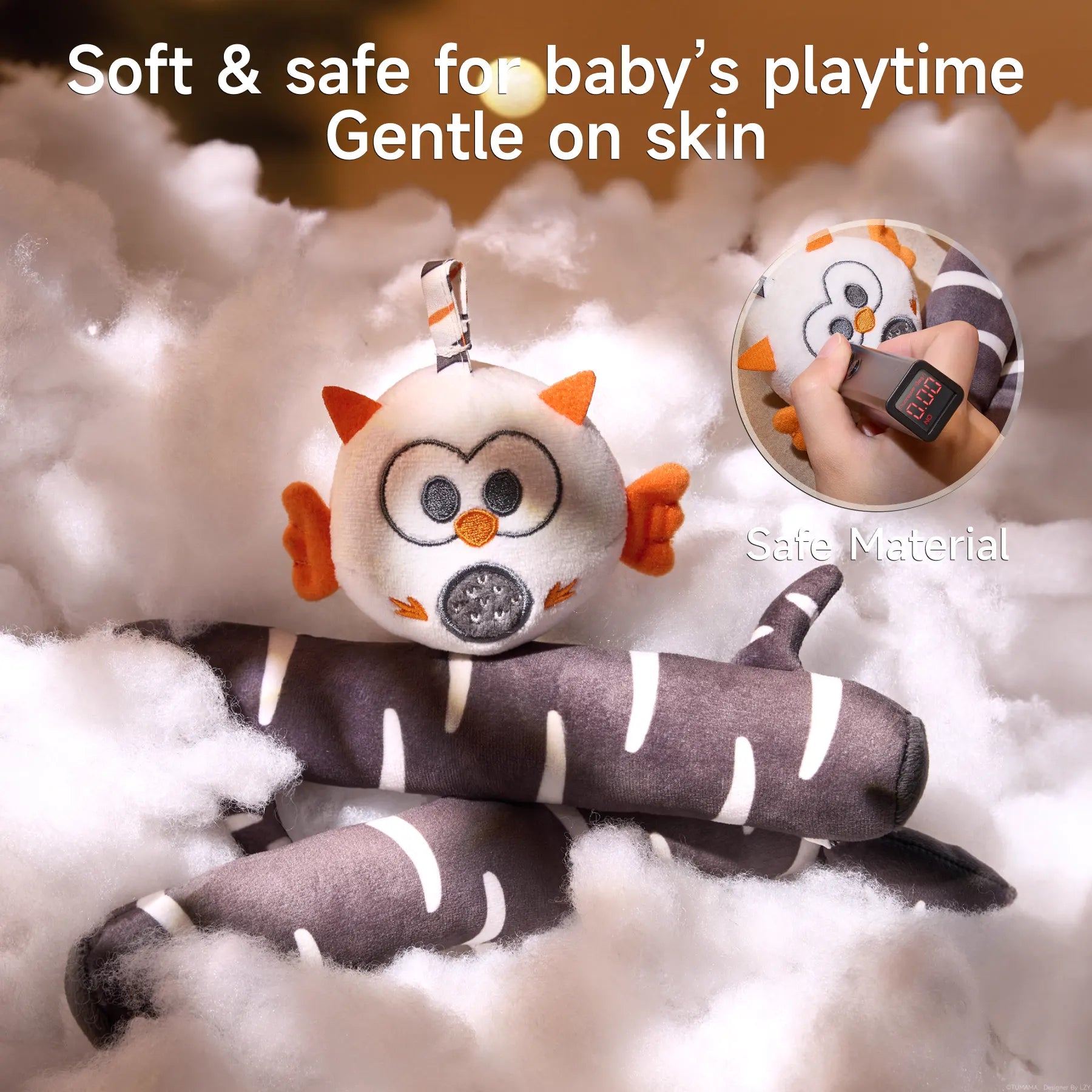 Plush black-and-white birch-patterned branches and a round owl toy nestled in soft, cloud-like padding, with an inset close-up showing a tester measuring the fabric, overlaid with text ‘Soft & safe for baby’s playtime Gentle on skin’.