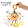 Hand holding a plush orange slice baby rattle toy with a built-in bell. The toy features a smiling cloud and yellow flower teether hanging below. Musical notes illustrate the jingling sound effect, designed to comfort and entertain babies while promoting sensory development.
