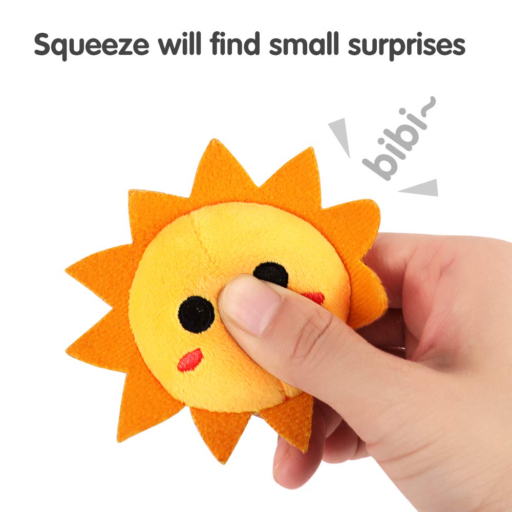 Close-up of a hand squeezing a cute plush sun-shaped baby toy with embroidered eyes and cheeks. The text indicates that squeezing the toy produces a fun sound surprise ("bibi~"), designed to entertain and stimulate babies’ auditory and tactile senses.