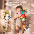 Baby lying in crib holding a colorful plush caterpillar whose underside is printed with measurement markings up to 43 cm to help track infant growth