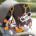 Two high-contrast black and white sensory toys clipped onto a gray stroller canopy. The cube and pyramid-shaped hanging toys feature cute animal faces, colorful teethers, rattles, and textured shapes, designed for outdoor play and easy portability, keeping babies entertained while on the go.