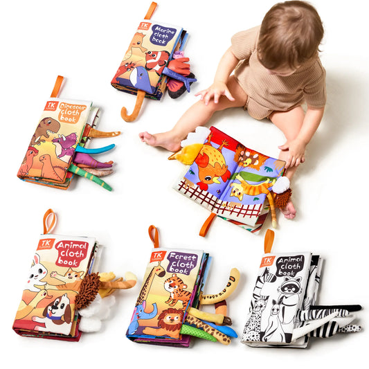Set of five soft cloth baby books, each with a unique theme and 3D animal tails sticking out from the sides. Themes include Dinosaur Cloth Book, Marine Cloth Book, Animal Cloth Book, Forest Cloth Book, and Black & White Animal Cloth Book. Each book features colorful or high-contrast illustrations and various textured tails designed to stimulate babies’ sensory development and early learning.