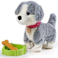 Interactive realistic stuffed toy puppy in gray and white plush with pink collar and tag, standing beside a green dog bowl and orange bone accessory on white background