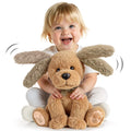 Smiling toddler holding the Interactive Singing and Talking Plush Toy, a soft plush dog with moving ears that engages children with songs and interactive talking features.