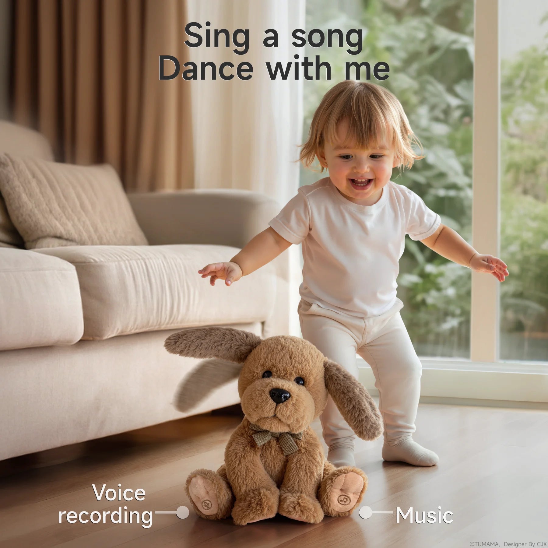 A toddler in white clothes stands behind an interactive plush dog toy with floppy ears on the living room floor, showing the toy’s voice recording and music features.