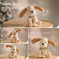 Interactive stuffed animal toy dog with beige fur and floppy brown ears, shown on a round wooden table. The image demonstrates its movement features, including shaking its body side to side and fluttering its ears up and down, with labeled motion effects and multiple frames highlighting right, left, and ear-flapping motions.