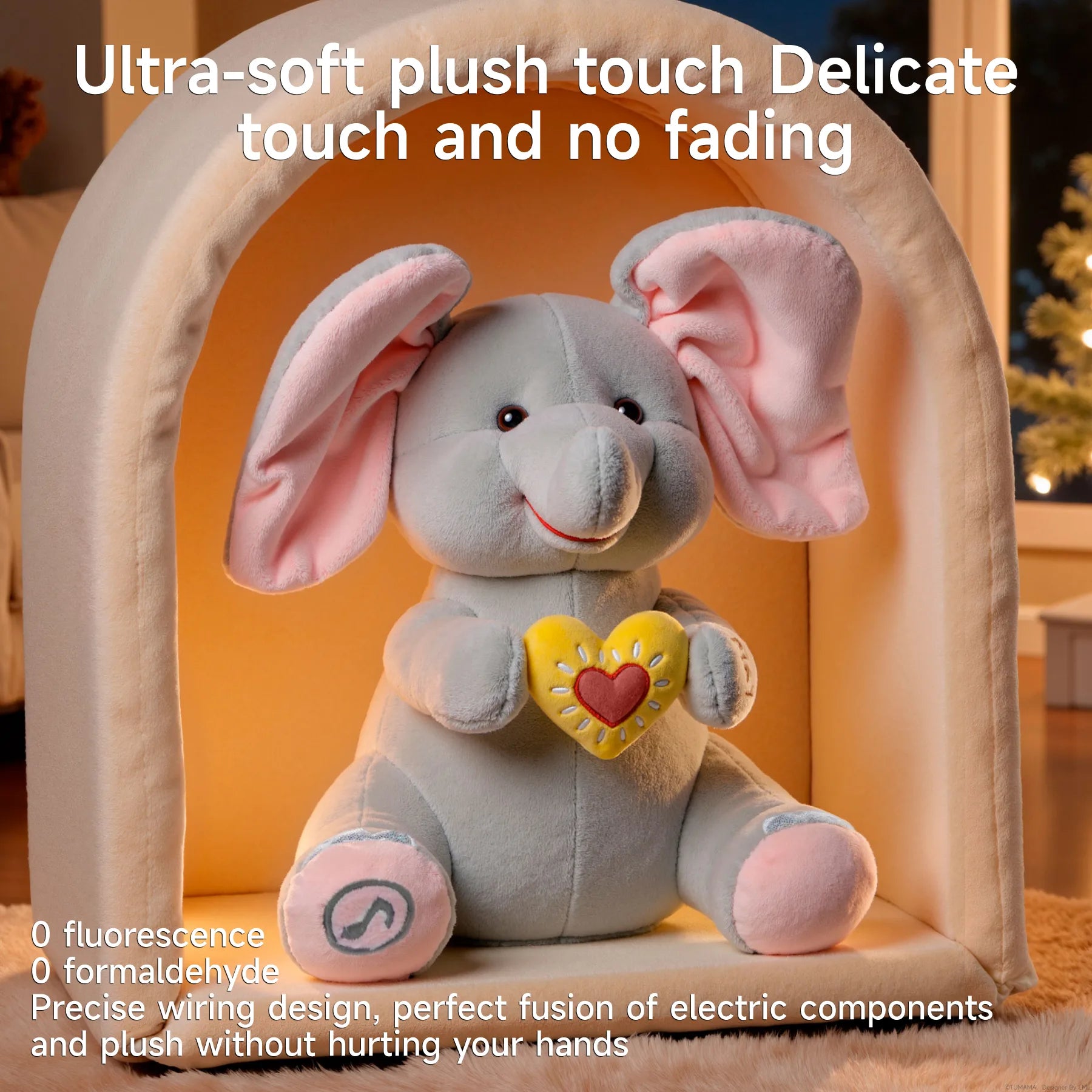 Plush elephant toy with large pink ears and a yellow heart sits inside a cozy fabric archway. Text reads: “Ultra-soft plush touch Delicate touch and no fading.” Additional points highlight: “0 fluorescence, 0 formaldehyde, Precise wiring design, perfect fusion of electric components and plush without hurting your hands.”