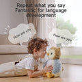 Smiling child lying on the floor talking to an interactive owl plush toy. Speech bubbles show both the child and the toy saying 