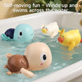 Close-up of colorful wind-up animal bath toys, including turtles and ducks, swimming across the bathtub water, showcasing their self-moving feature for interactive bath time play.