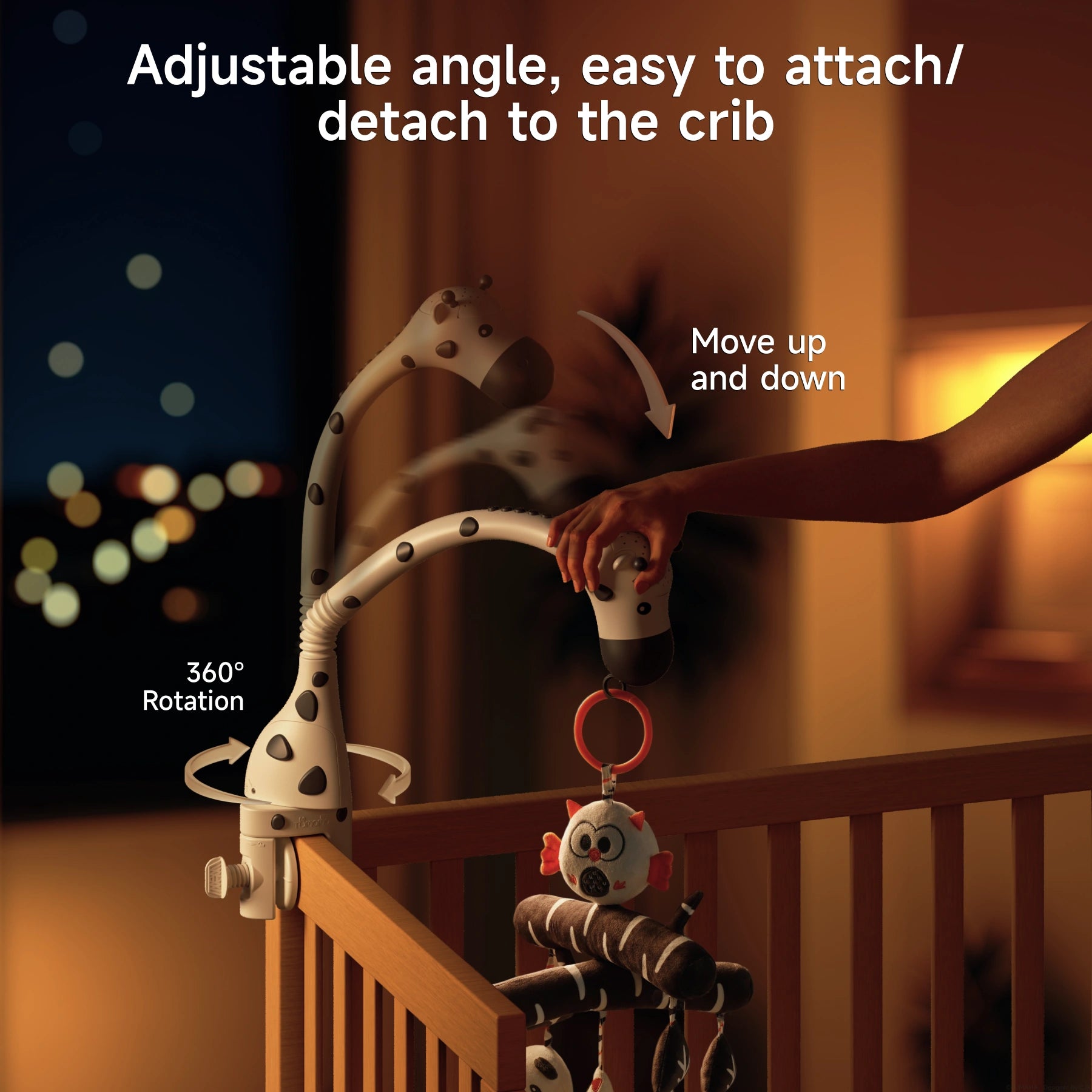 Hand adjusting zebra-themed crib mobile arm with 360-degree rotation and up-and-down movement, attached to wooden crib.