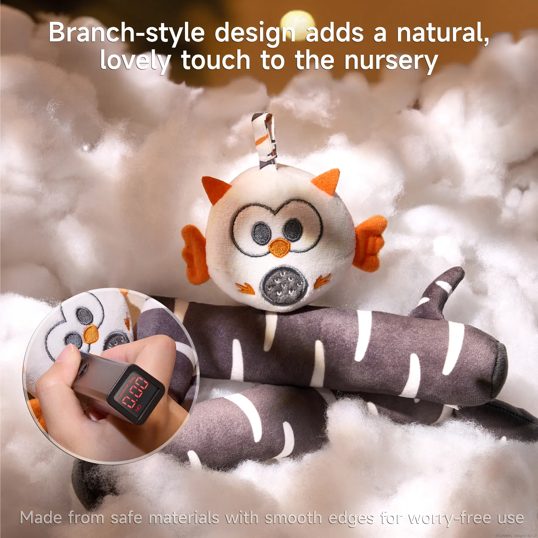 Close-up of plush owl toy on branch-style crib mobile design, surrounded by soft white material, with inset showing safe material test reading.
