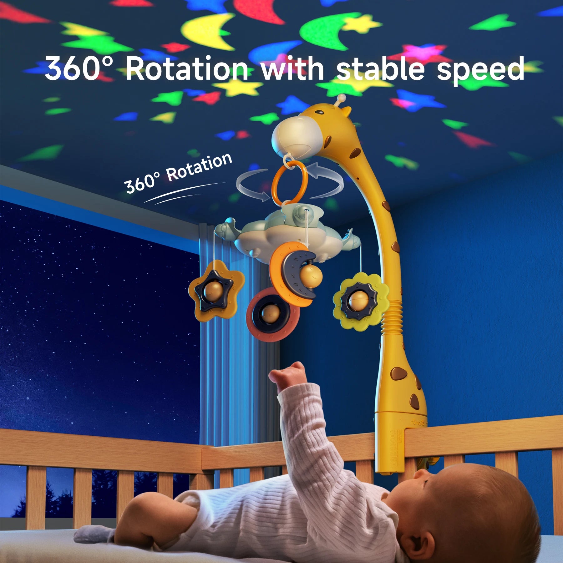 A baby lies in a wooden crib, reaching up toward a giraffe-shaped crib mobile. The mobile has colorful hanging toys shaped like stars and moons, which rotate in a circle. The ceiling is lit up with colorful star and moon projections in red, green, blue, and yellow. White overlay text reads “360° Rotation with stable speed” and “360° Rotation.”