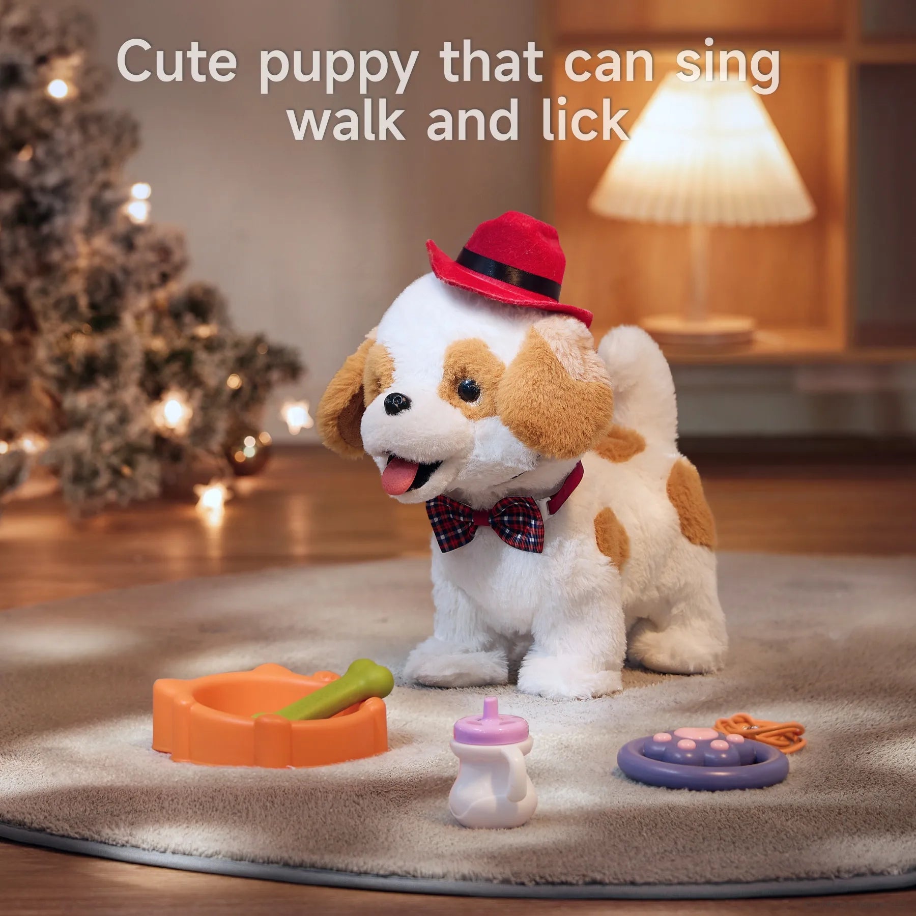 Plush electric toy dog wearing a red hat and plaid bowtie sits on a carpet in a cozy, softly lit room with a Christmas tree and lamp in the background. In front of the dog are toy accessories: an orange pet bowl with a green bone, a white and purple baby bottle, and a purple paw-shaped leash controller. Text reads: 'Cute puppy that can sing, walk and lick'.