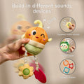 Hand holding a smiling plush onion-shaped baby toy with built-in sound features, including a flower squeaker, rustling paper, and dangling textured teethers in various shapes; inset images highlight sound effects such as 'ding', 'bibi', and 'sasa', along with circular, square, and star-shaped rings.