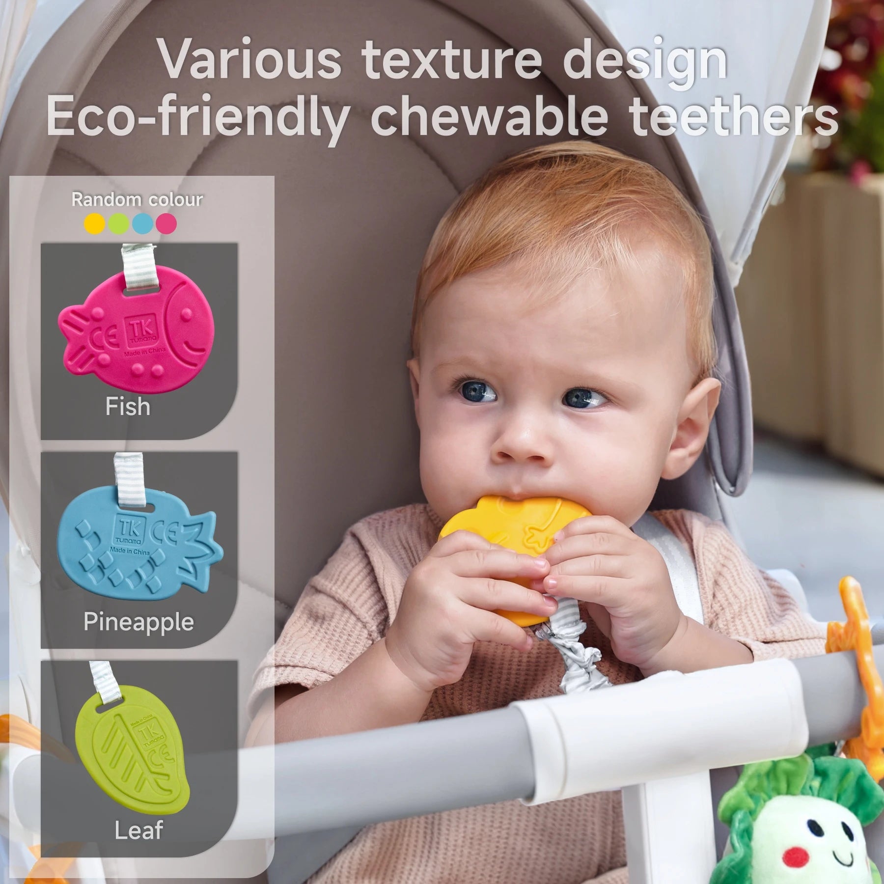 Baby seated in a stroller chewing on a yellow teether shaped like a pineapple; side panel displays other eco-friendly textured teether designs including a pink fish, blue pineapple, and green leaf, with note of random color variation. Text reads: 'Various texture design, Eco-friendly chewable teethers'.