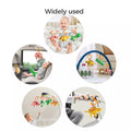 Collage of circular images showing three reversible plush dinosaur hanging toys used in various settings: clipped to a crib rail, attached in a car seat, hanging on a play gym arch, suspended from a mobile, and hooked to stroller handlebars