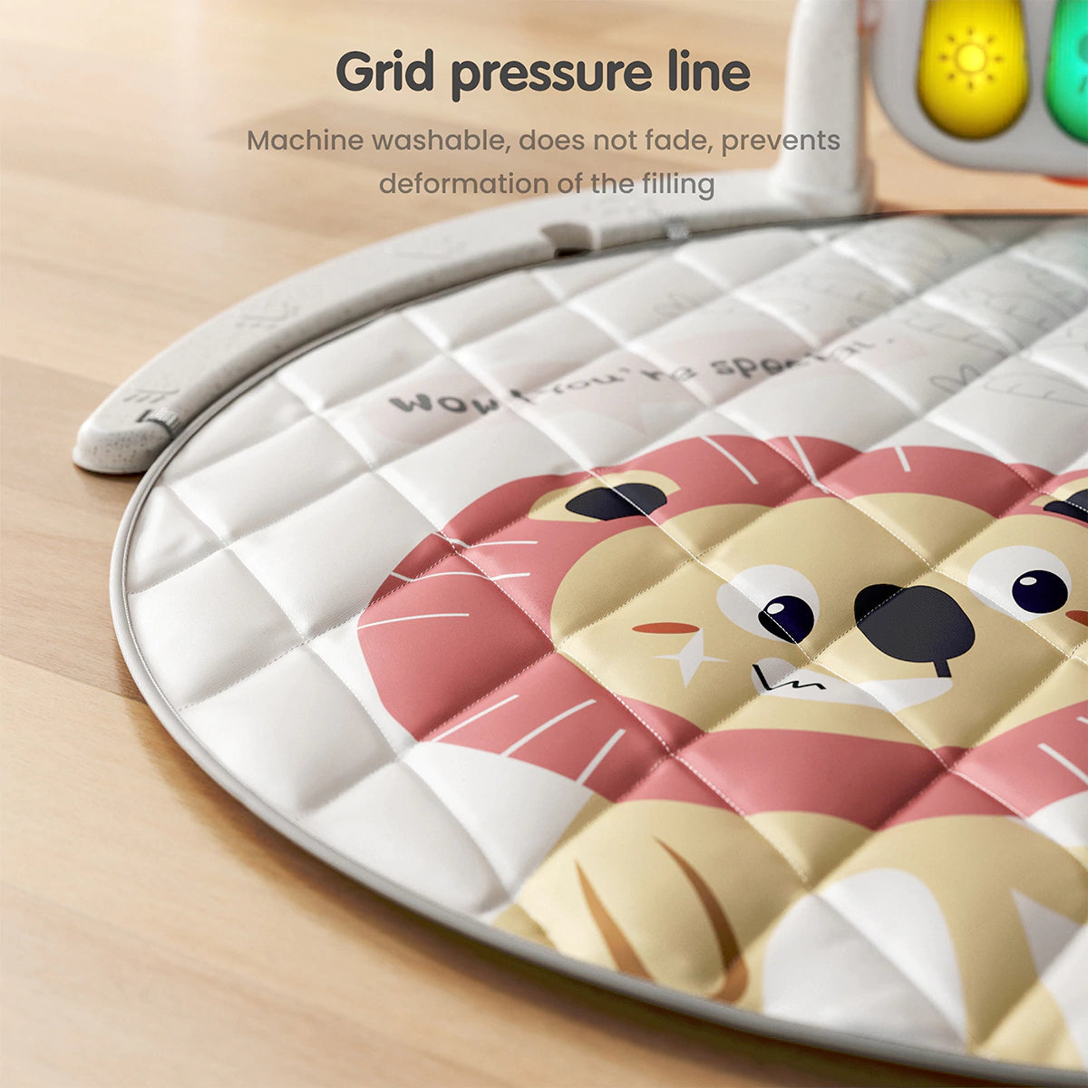 Close-up of baby play mat with grid pressure line design featuring a cute lion print, machine washable, prevents deformation of filling, and resists fading.