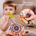 Baby chewing on non-toxic soft plastic teether attached to sensory tissue box toy, safe teething toy for infants with safety test shown