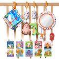 A colorful baby sensory toy set hanging from a rope, featuring a plush hedgehog, a soft mirror, a red octopus, a bunny head, a fabric baby book with ocean animals, and a green alligator plush, each suspended with patterned fabric straps and orange hooks.