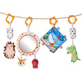 A colorful baby sensory toy set hanging from a rope, featuring a plush hedgehog, a soft mirror, a red octopus, a bunny head, a fabric baby book with ocean animals, and a green alligator plush, each suspended with patterned fabric straps and orange hooks.