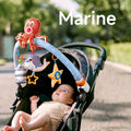 A baby lying in a stroller, gazing up at a marine-themed arch toy featuring a plush octopus, whale, starfish, and striped fish. The toy is securely attached to the stroller, providing sensory and interactive play on the go.