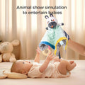 Baby lying on a bed reaching up towards a zebra baby security blanket being held above