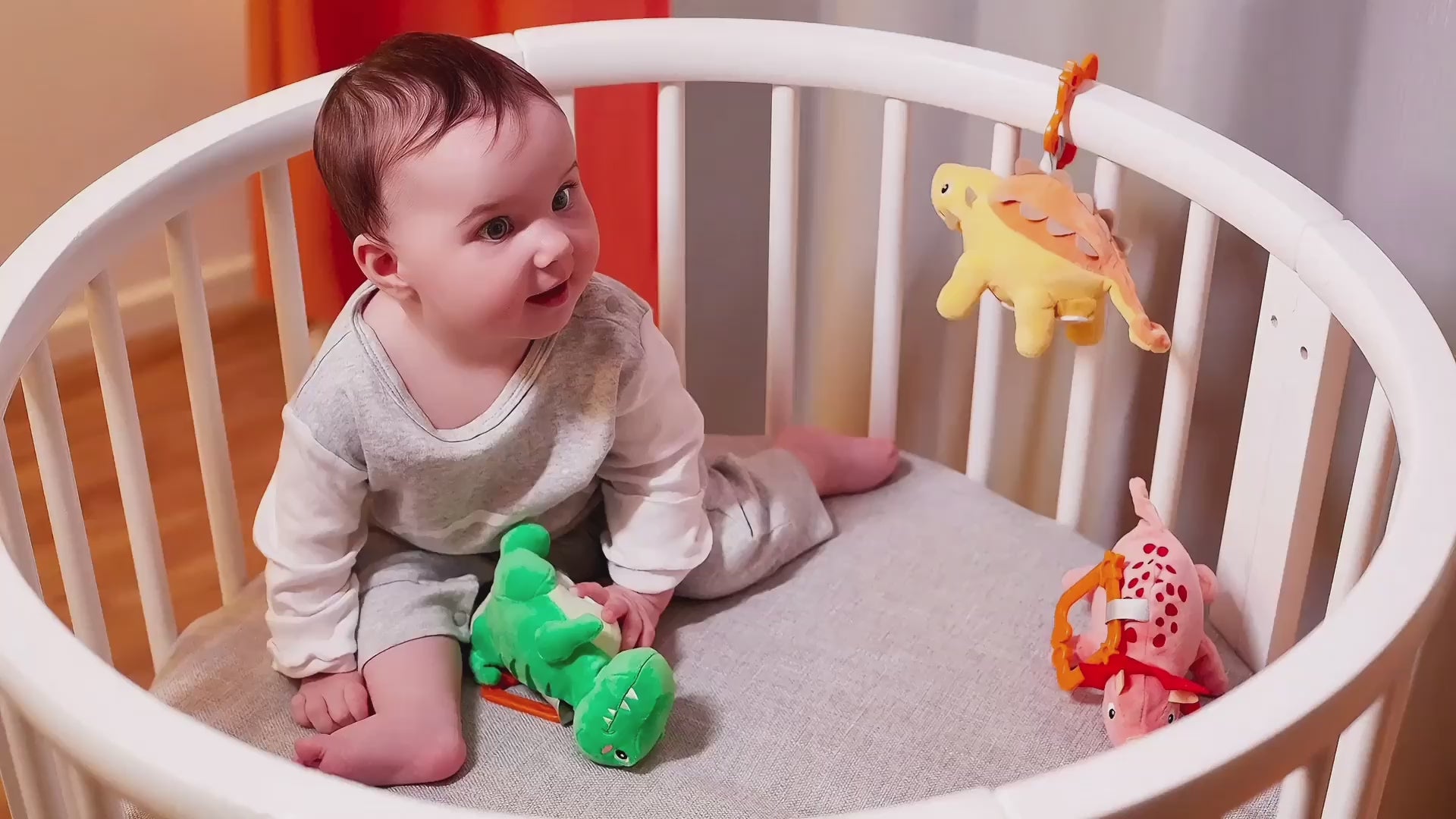 Little-boy-playing-with-hanging-Stuffed-dinosaur-toy