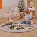 LITTLE BOY IS PLAYING WITH DINOSAUR RACE TRACK CAR TOY SET INDOORS