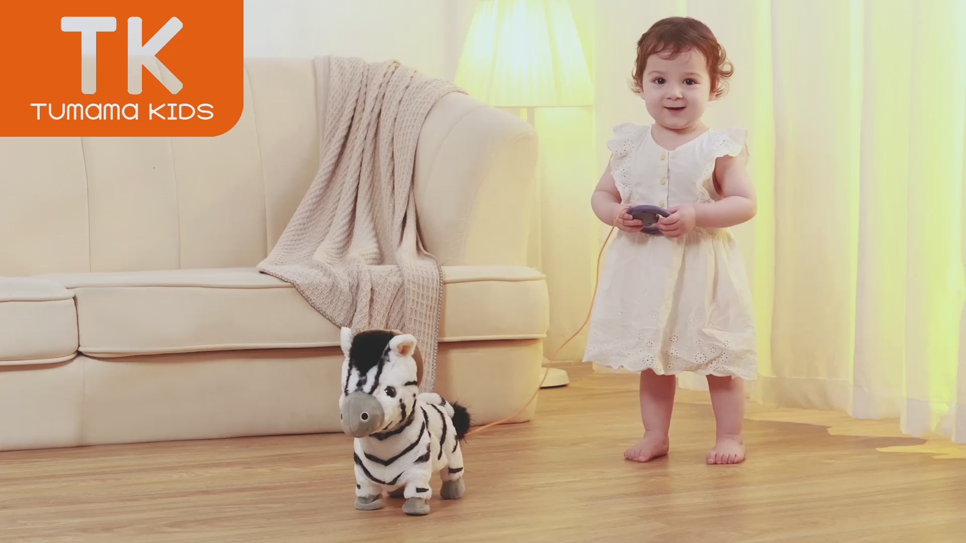 Little girl playing with electronic plush zebra toy indoors